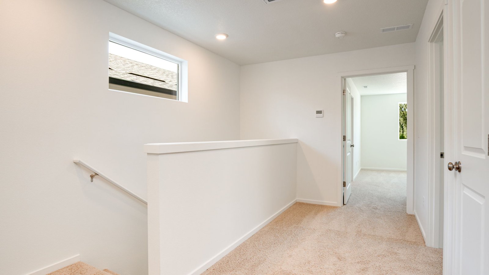 Hallway with wall-to-wall carpet