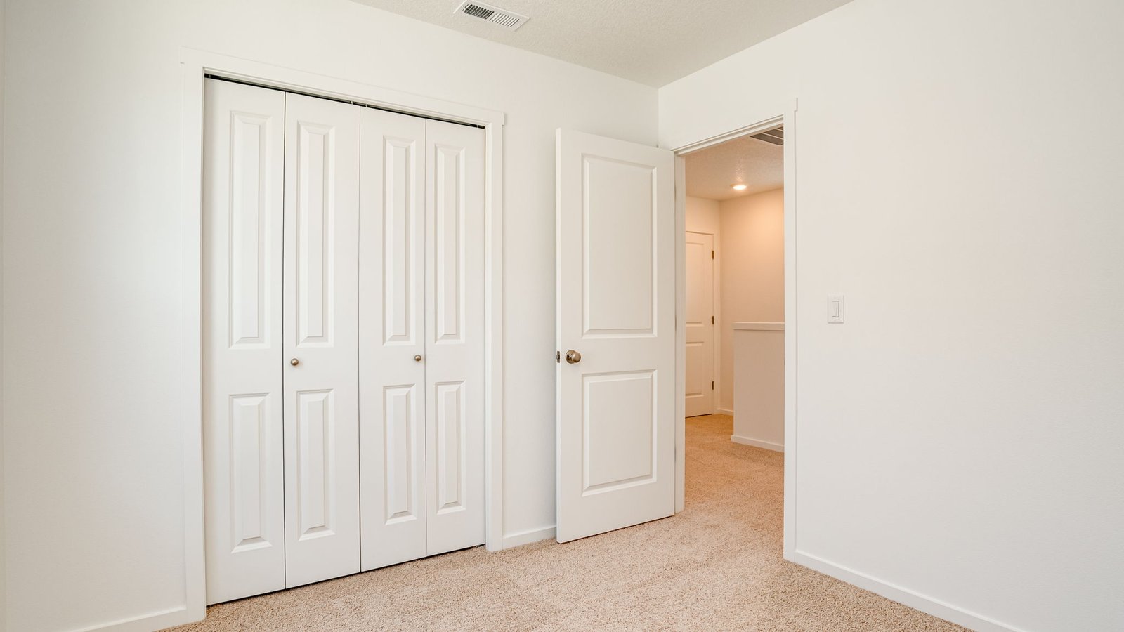 Bedroom with wall-to-wall carpet and a closet