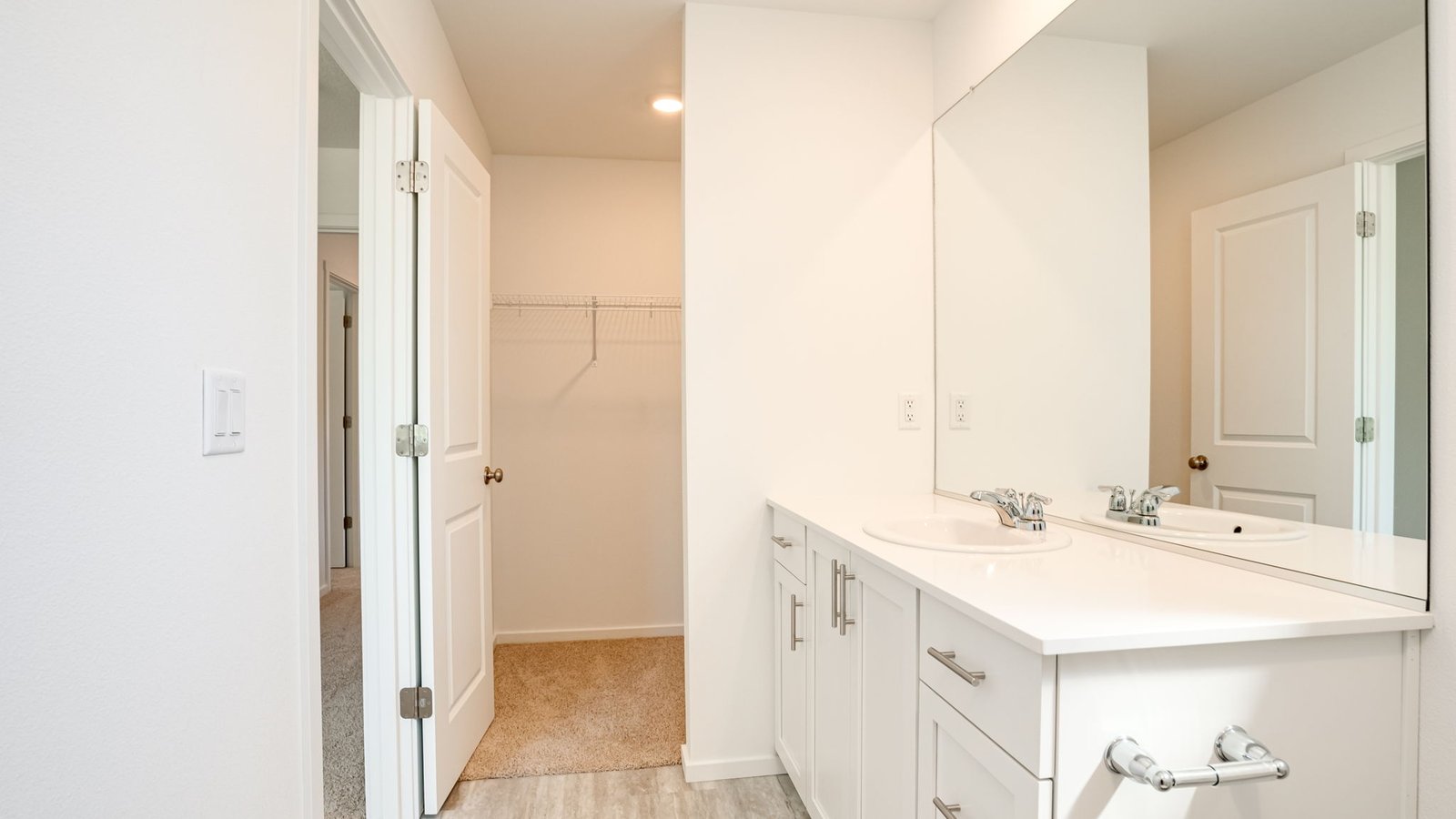Primary bathroom with quartz counters and a walk-in shower