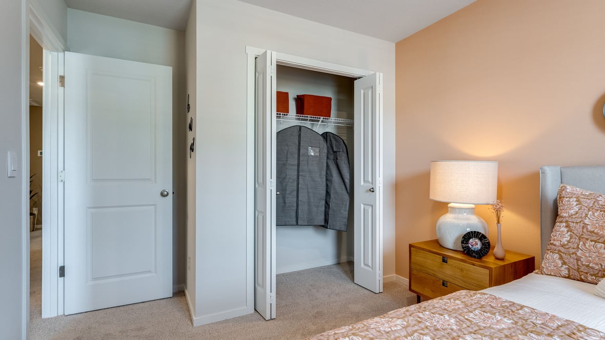Bedroom with wall-to-wall carpet and a closet