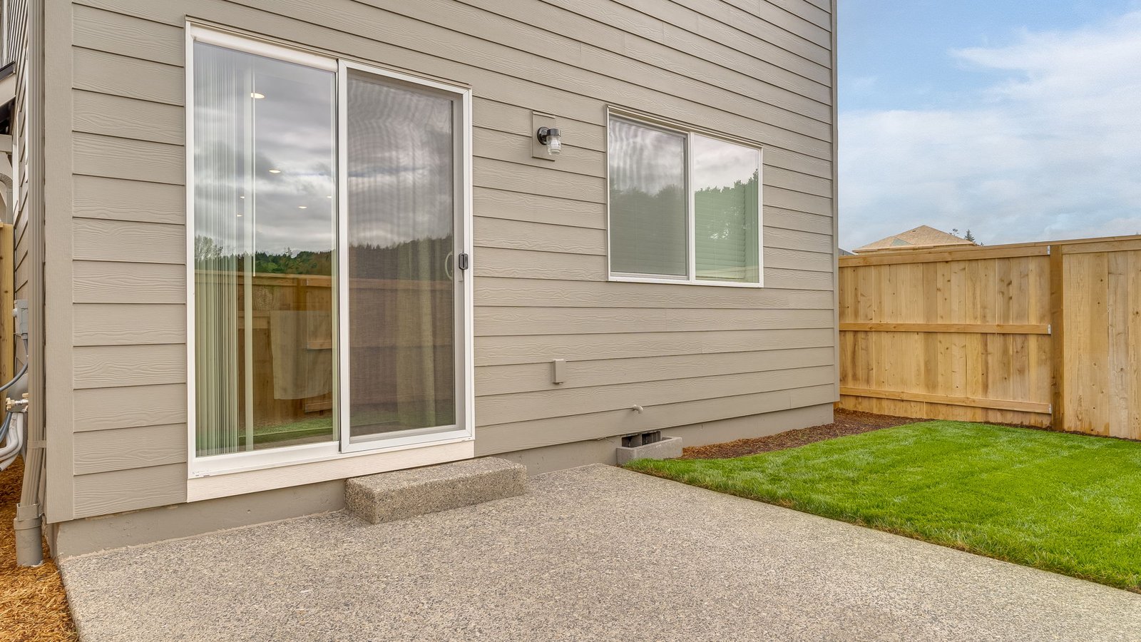 fenced backyard with a concrete patio