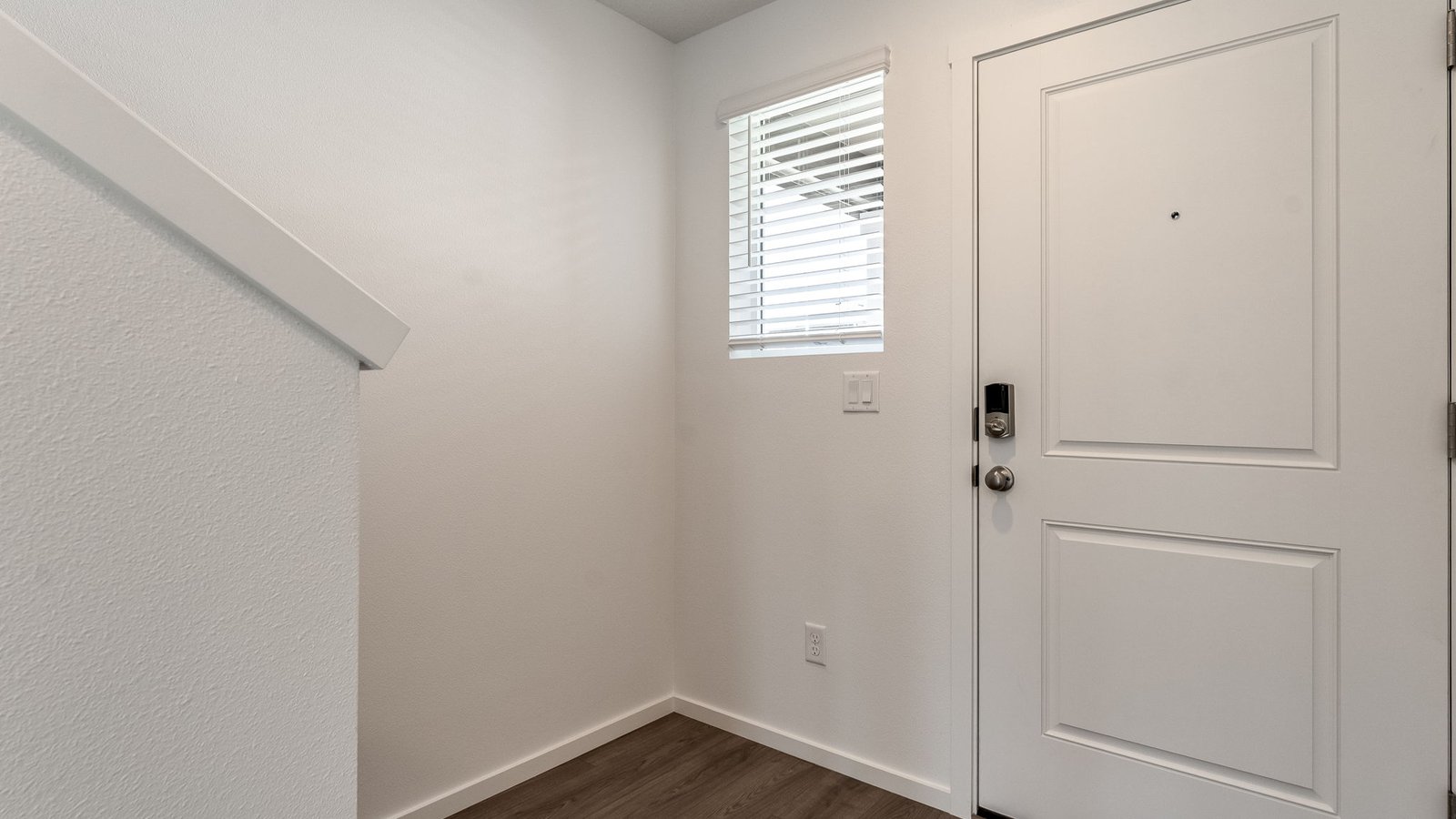 Entryway with a coat closet and laminate flooring