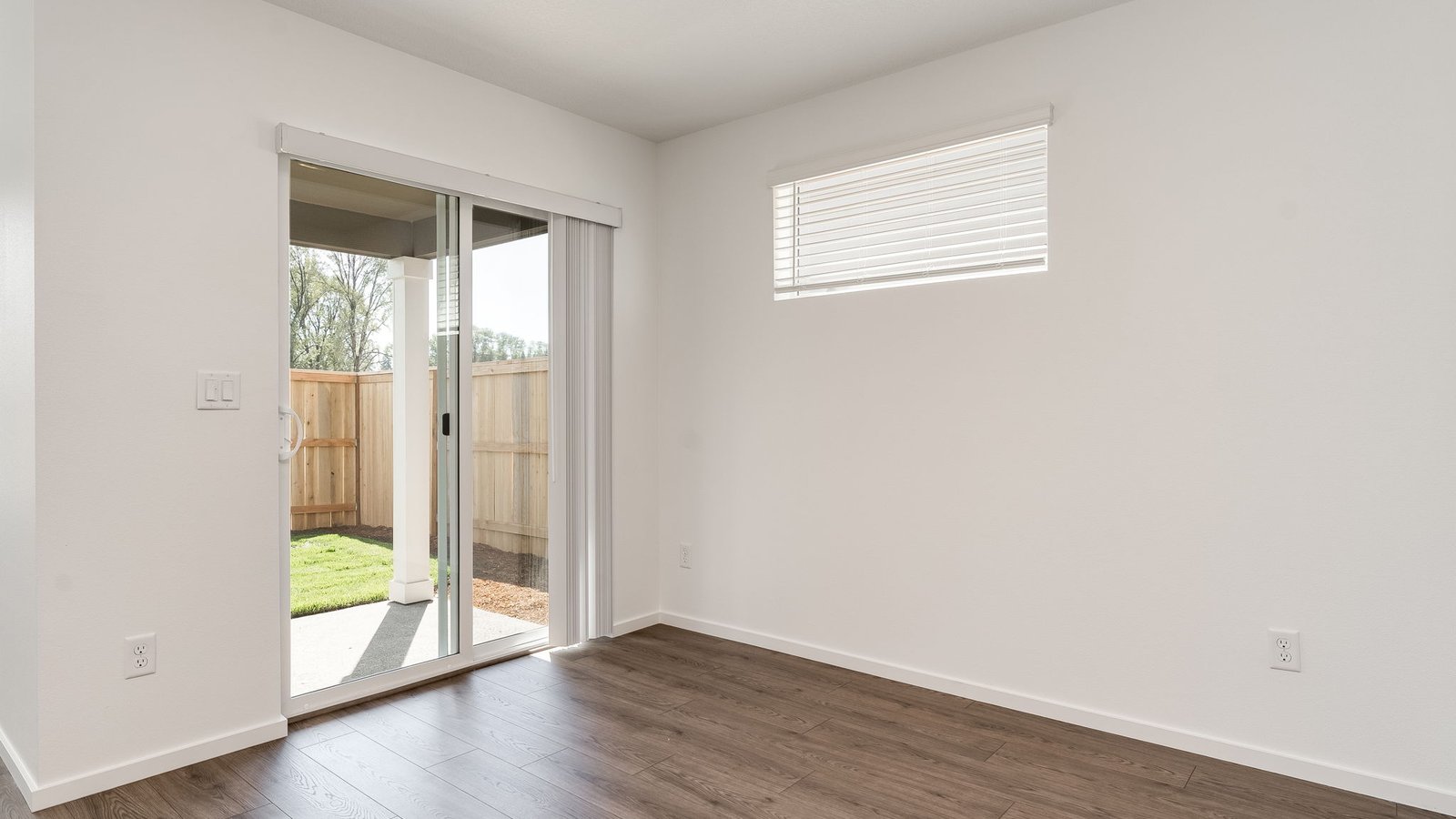 Dining area with a sliding glass door to a fenced backyard