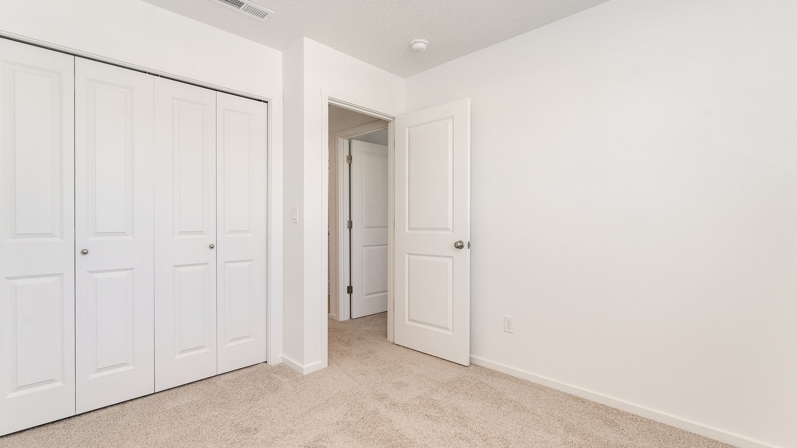 Bedroom with wall-to-wall carpet and a closet