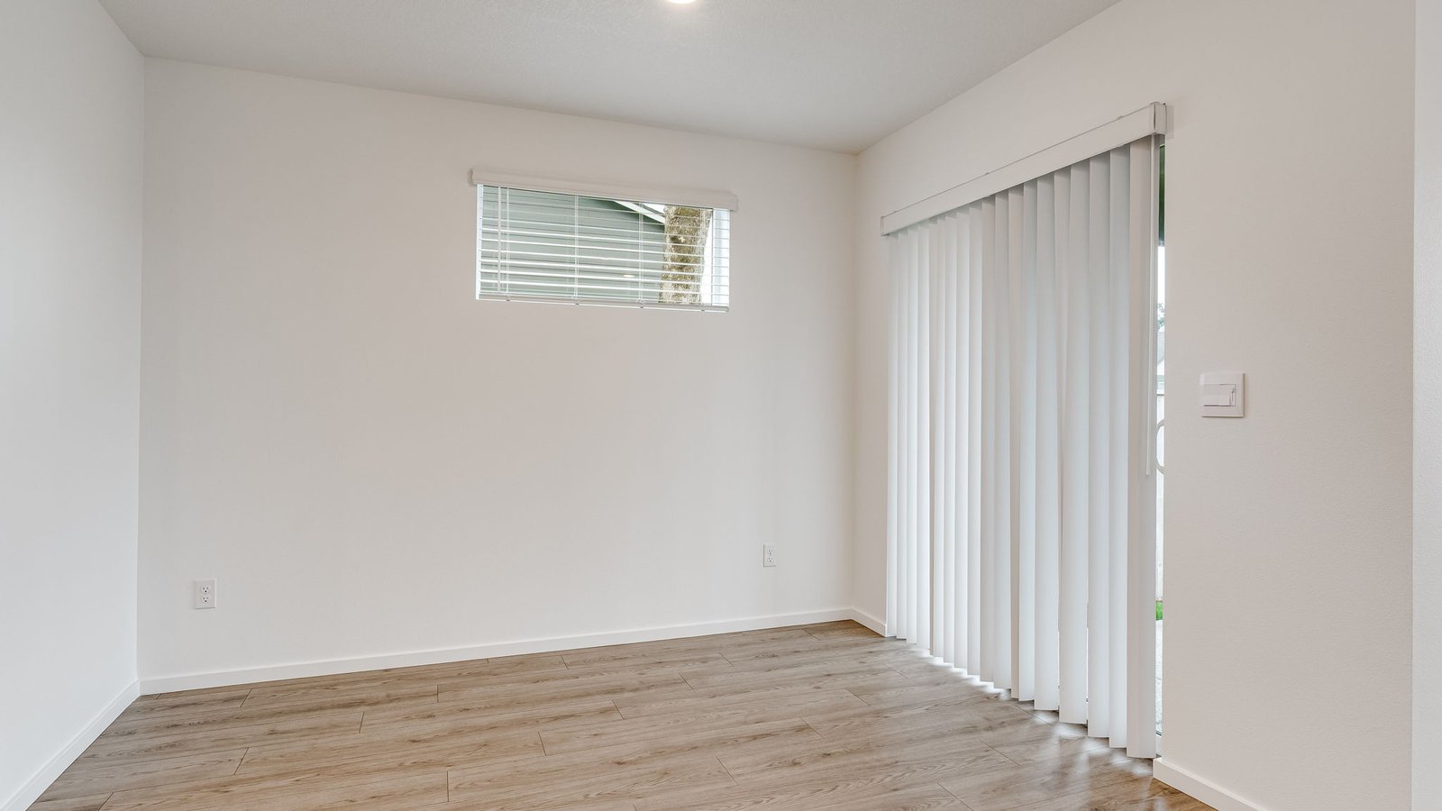 Dining area with a sliding glass door to a fenced backyard