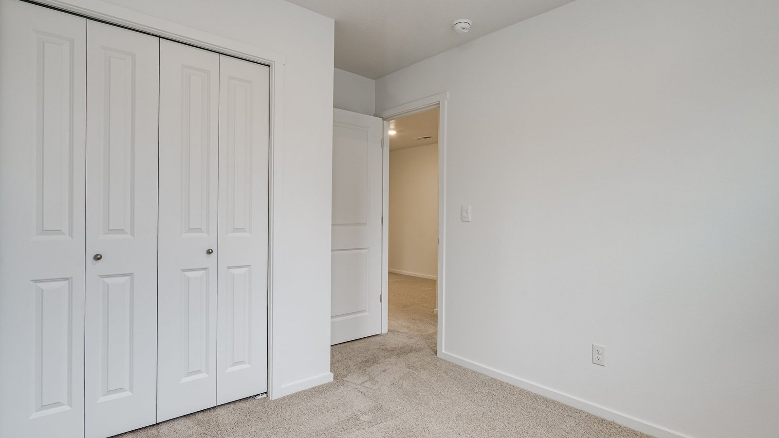 Bedroom with wall-to-wall carpet and a closet