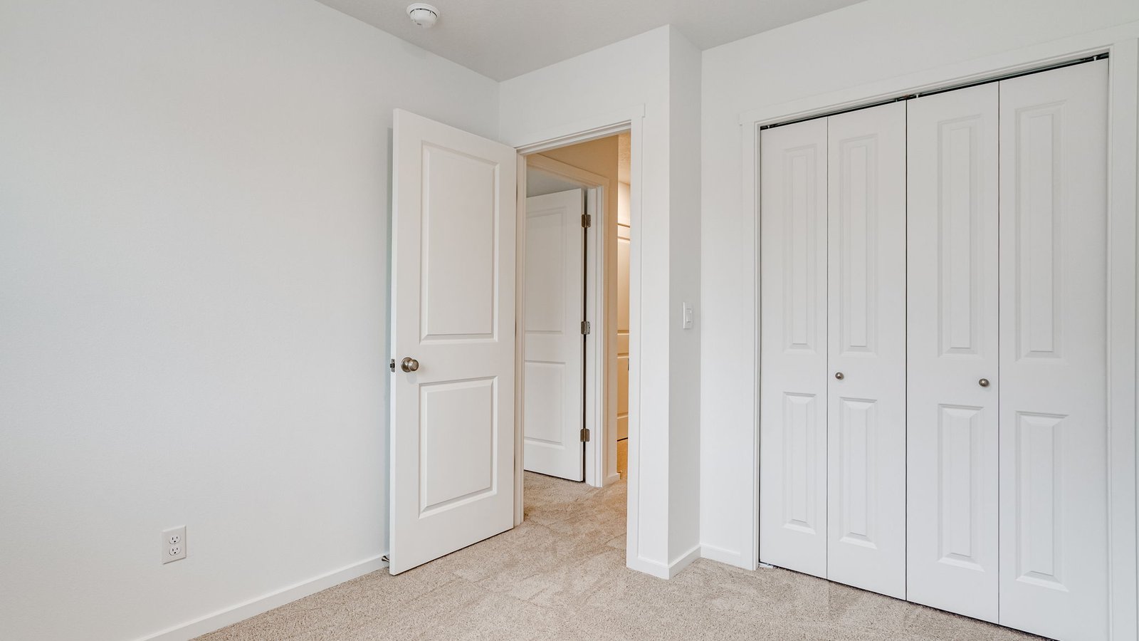 Bedroom with wall-to-wall carpet and a closet