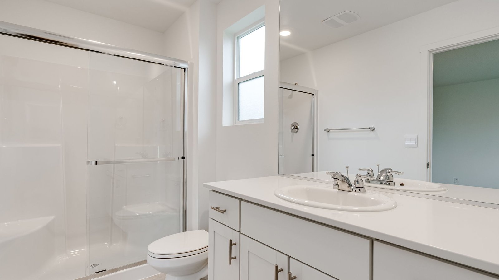 Primary bathroom with quartz counters and a walk-in shower