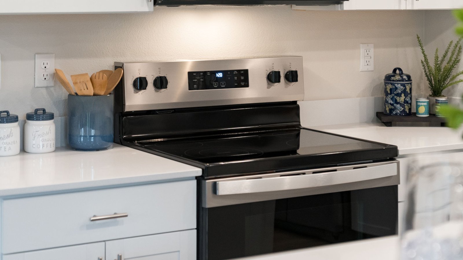 Kitchen with shaker cabinets, quartz counters, stainless steel appliances, pantry, and an island with a breakfast bar