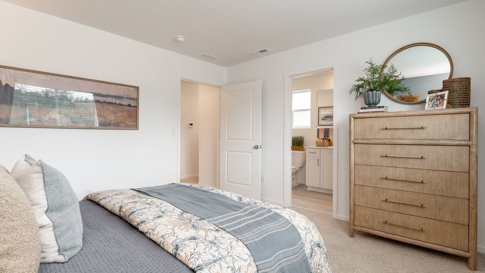 Primary bedroom with wall-to-wall carpet, a walk-in closet and an attached bathroom