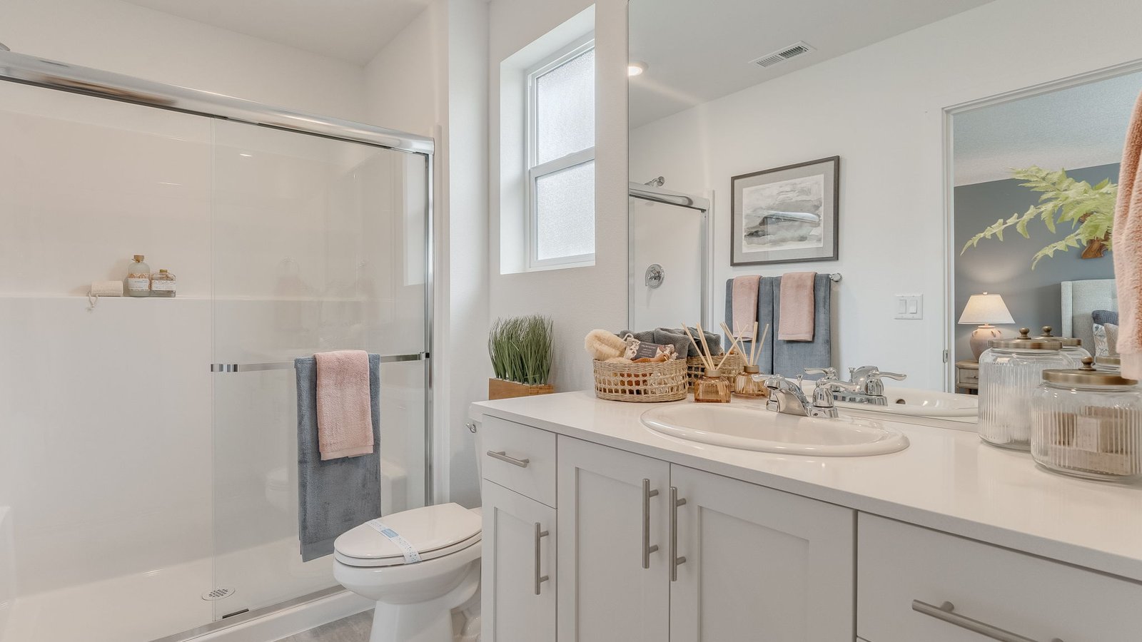 Primary bathroom with quartz counters and a walk-in shower