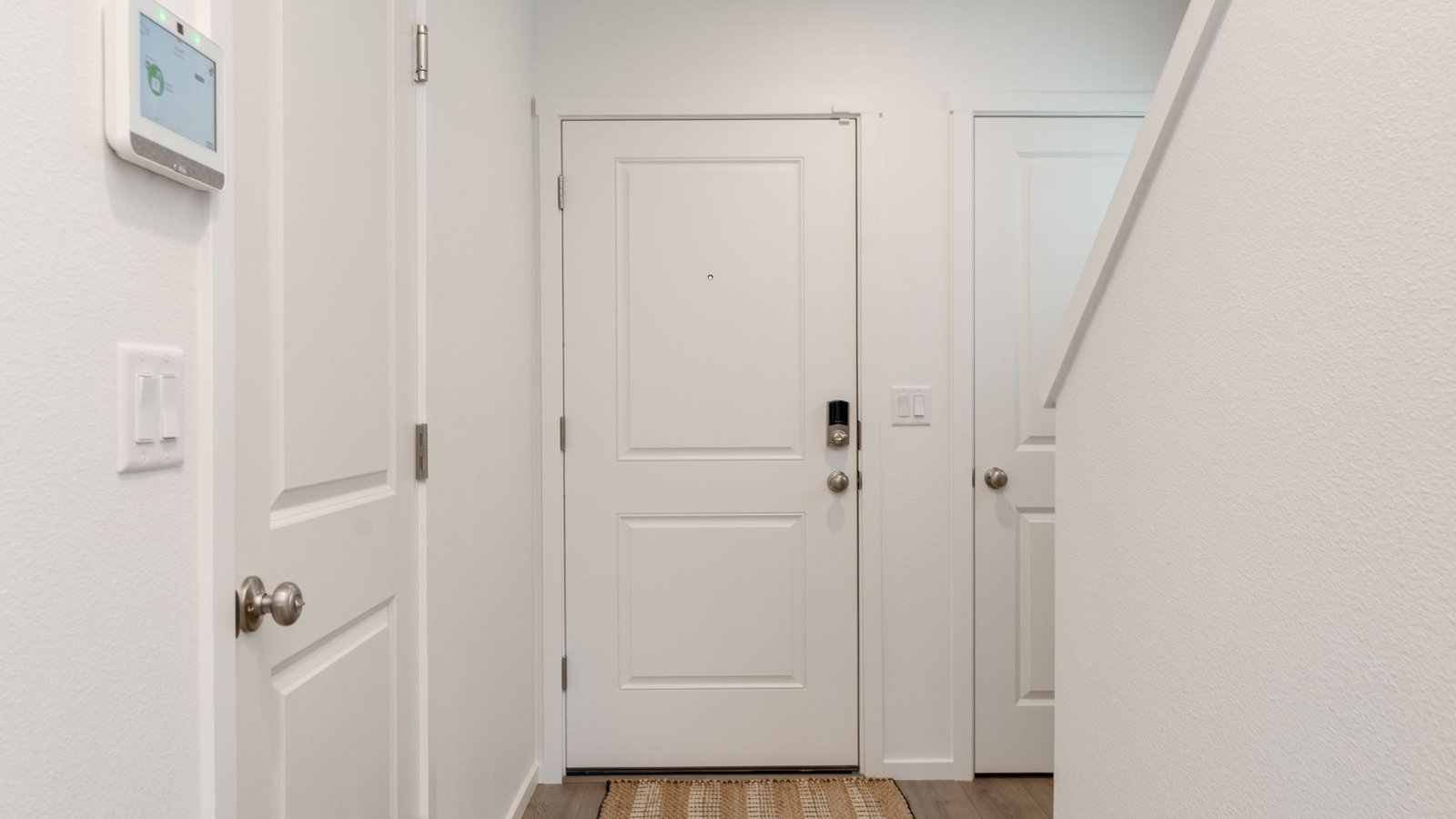 Entryway with a coat closet and laminate flooring