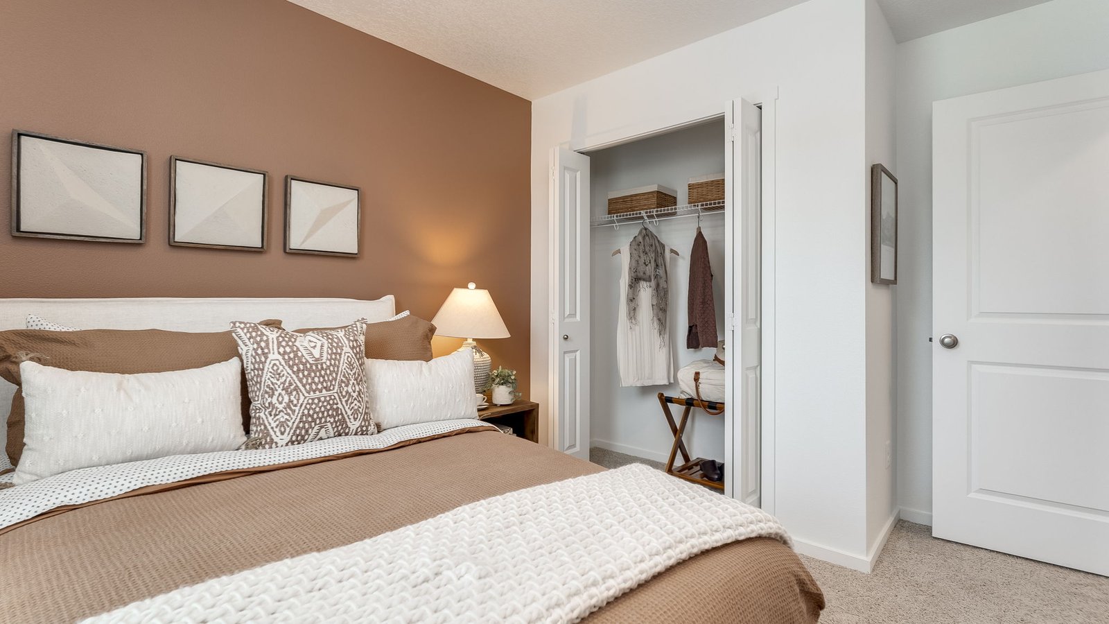 Bedroom with wall-to-wall carpet and a closet
