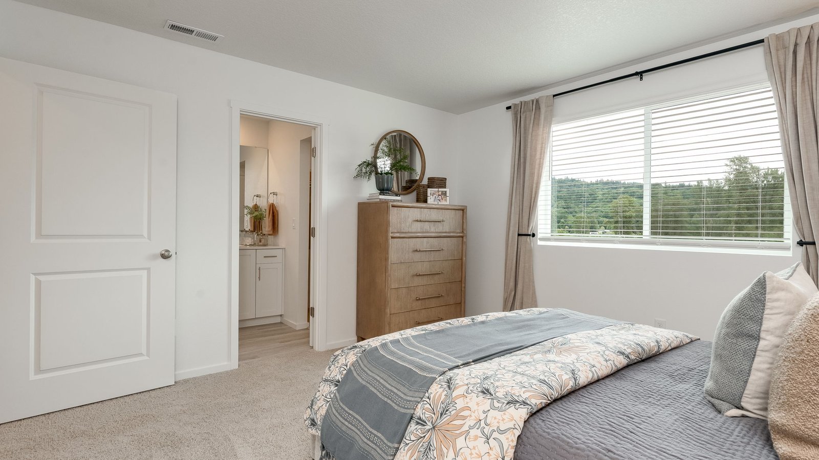 Primary bedroom with wall-to-wall carpet, a walk-in closet and an attached bathroom