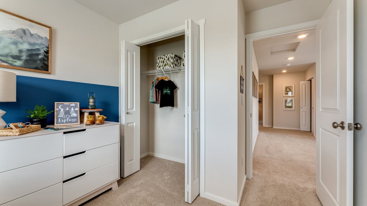 Bedroom with wall-to-wall carpet and a closet
