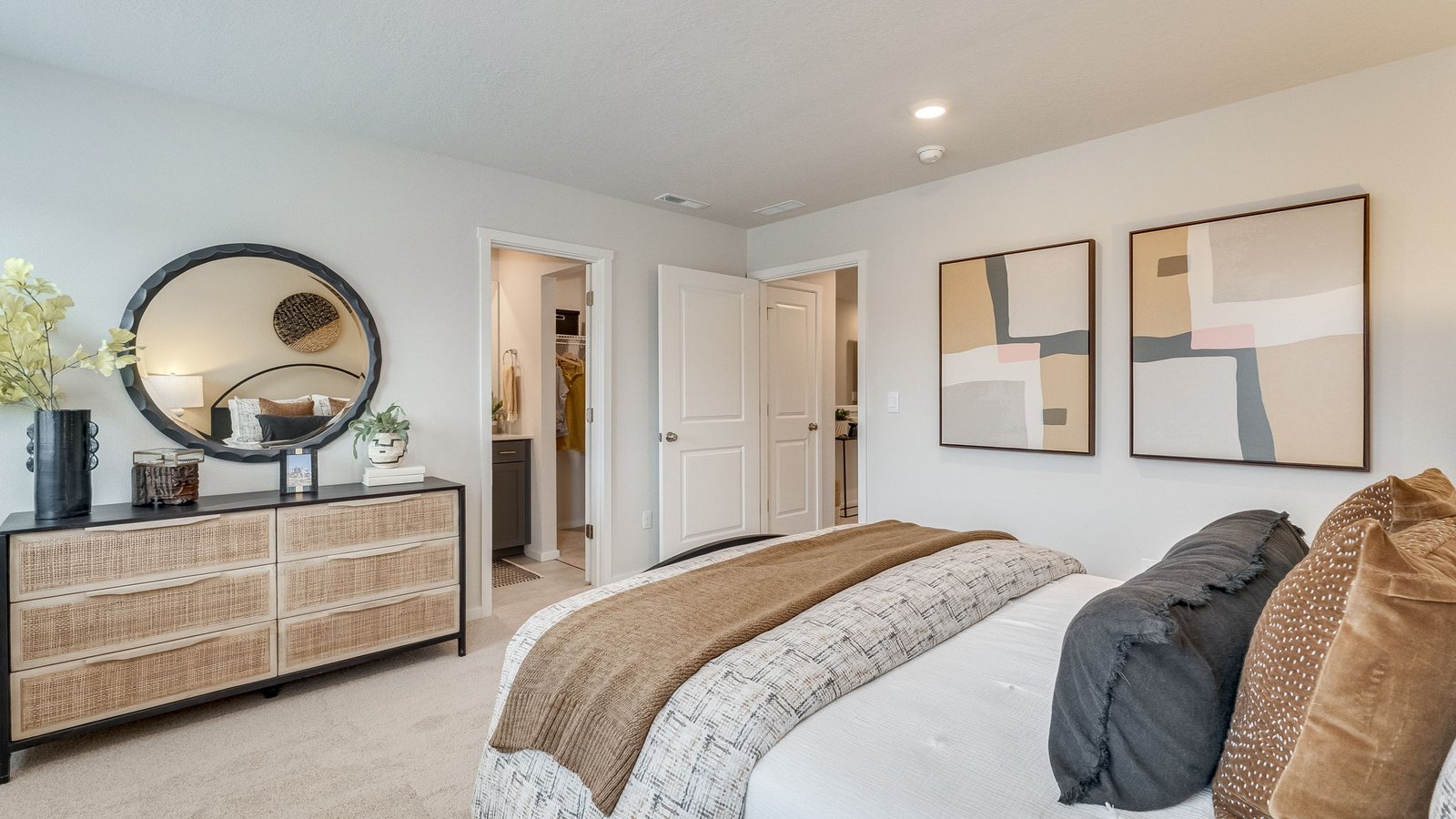 Primary bedroom with wall-to-wall carpet, a walk-in closet and an attached bathroom