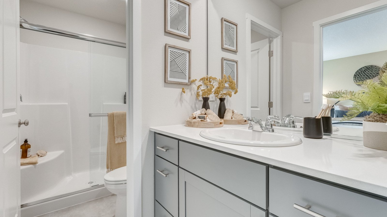 Primary bathroom with quartz counters and a walk-in shower