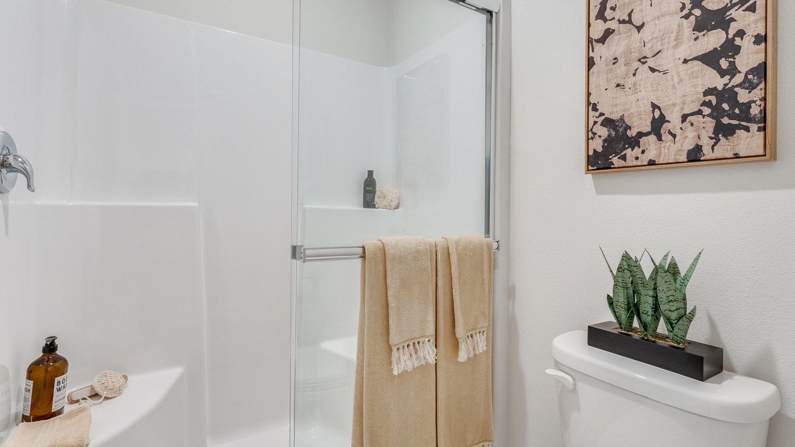 Primary bathroom with quartz counters and a walk-in shower