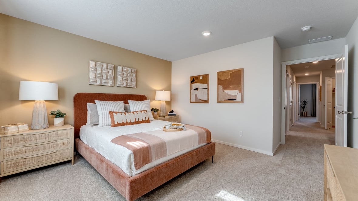 Primary bedroom with wall-to-wall carpet, a walk-in closet and an attached bathroom