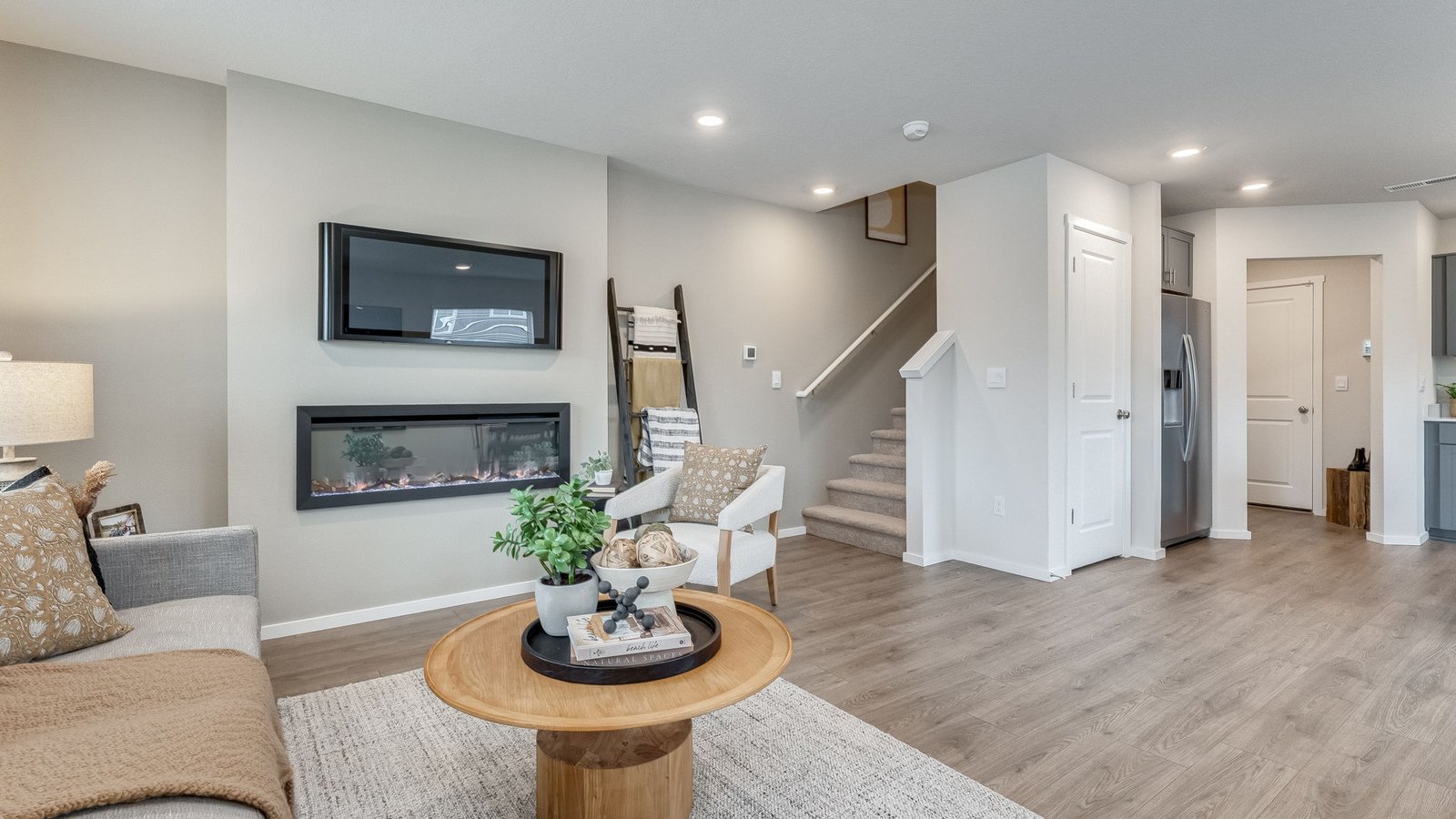Great room with laminate flooring and an electric fireplace