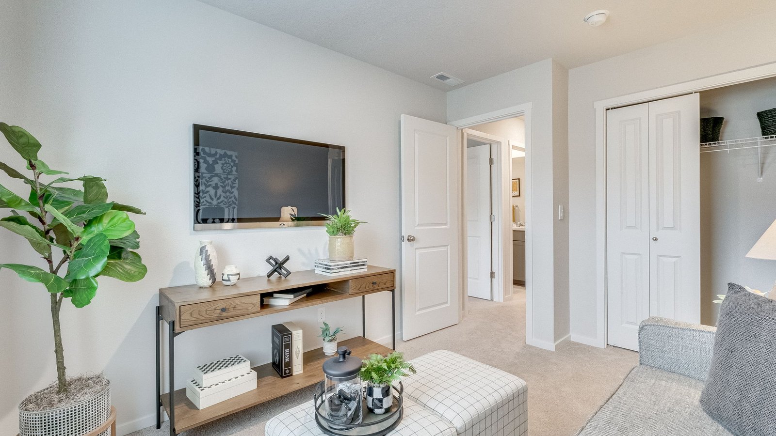 Bedroom with wall-to-wall carpet and a closet