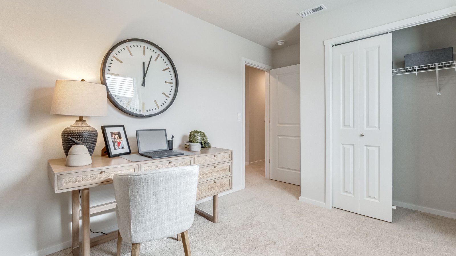 Bedroom with wall-to-wall carpet and a closet