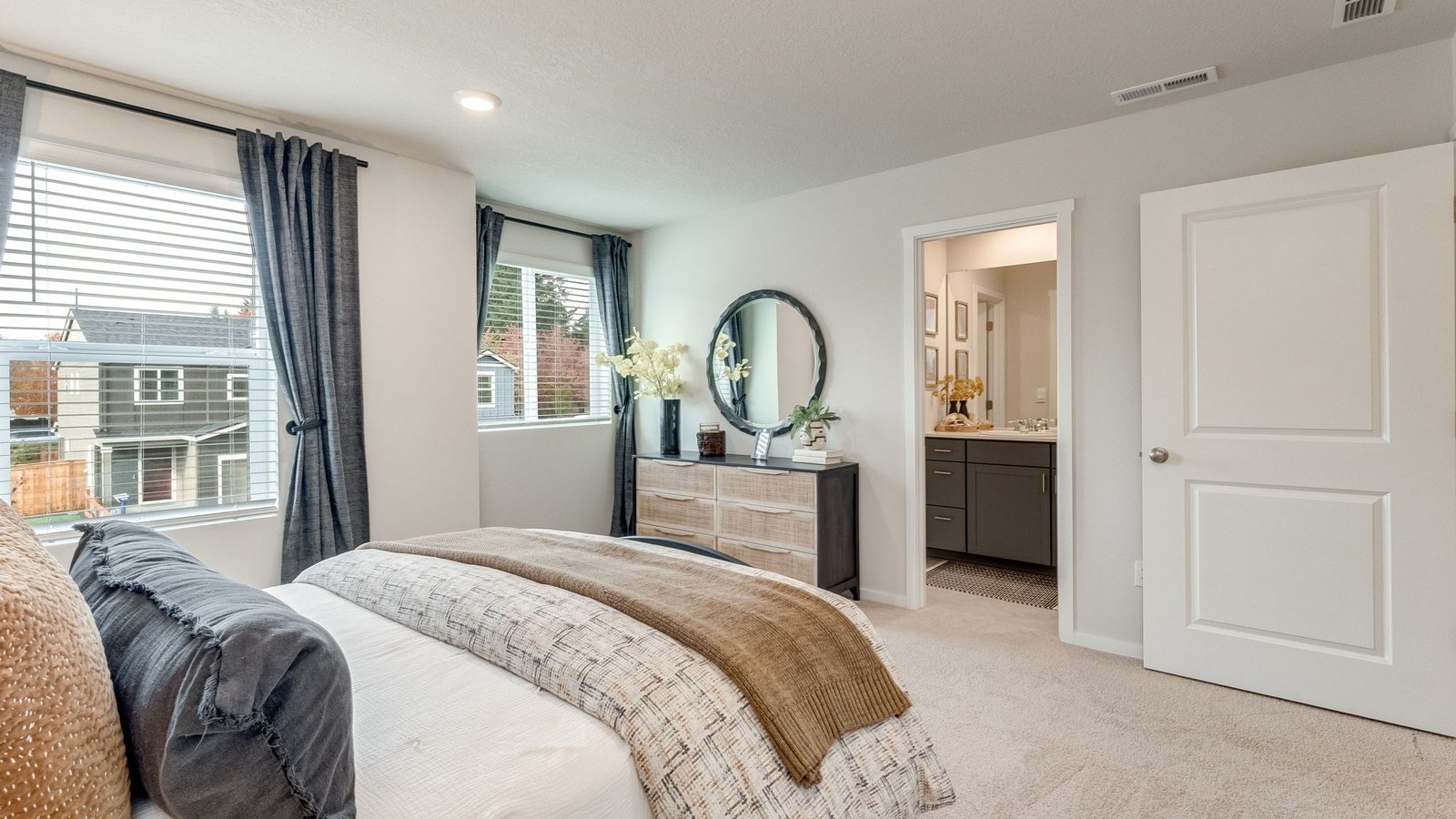 Primary bedroom with wall-to-wall carpet, a walk-in closet and an attached bathroom