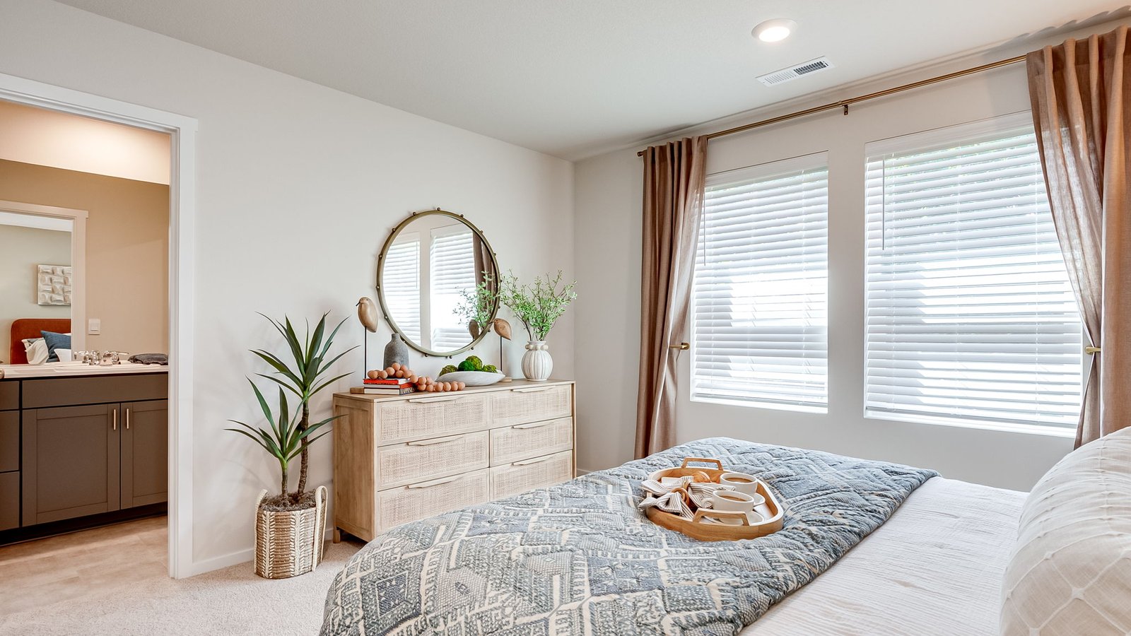 Primary bedroom with wall-to-wall carpet, a walk-in closet and an attached bathroom