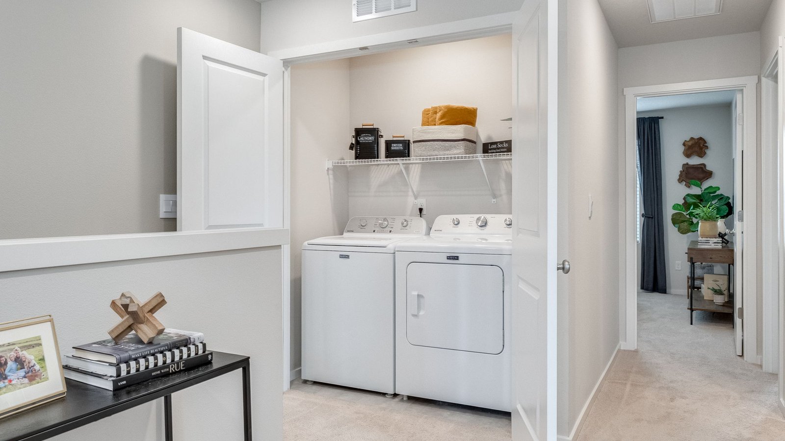 Laundry closet with wire shelves and washer and dryer hookups