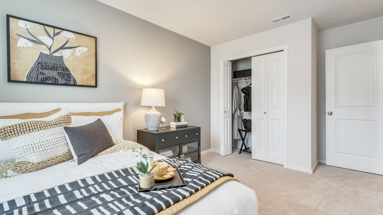 Bedroom with wall-to-wall carpet and a closet