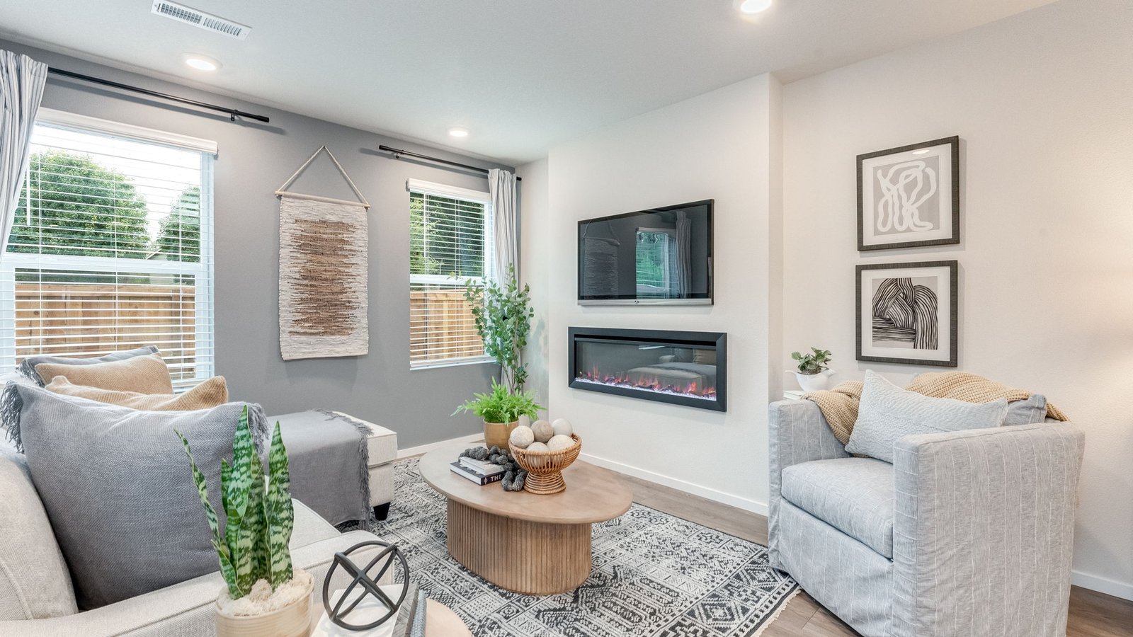 Great room with laminate flooring and an electric fireplace