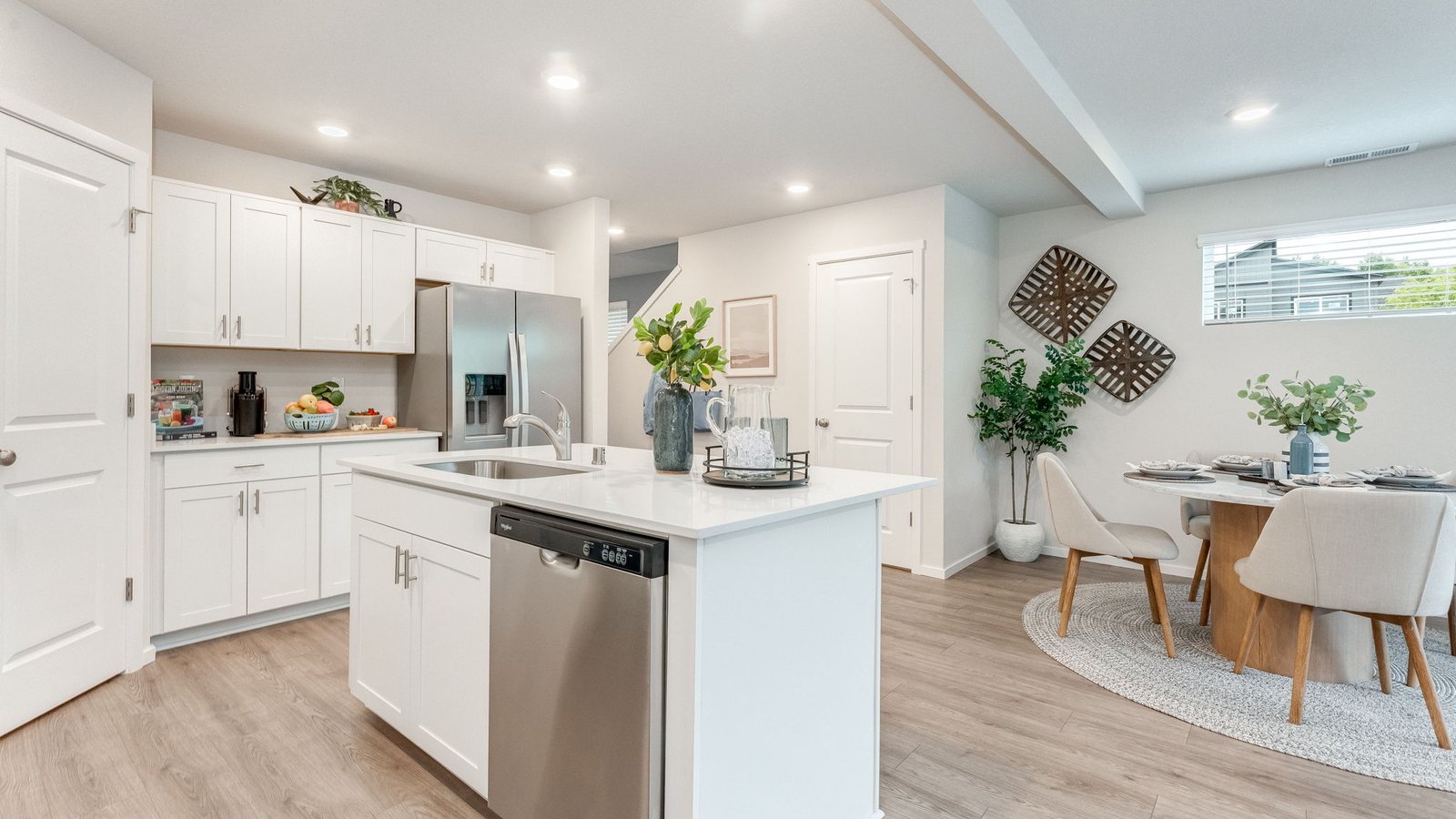 Kitchen with shaker cabinets, quartz counters, stainless steel appliances, pantry, and an island with a breakfast barKitchen with shaker cabinets, quartz counters, stainless steel appliances, pantry, and an island with a breakfast bar