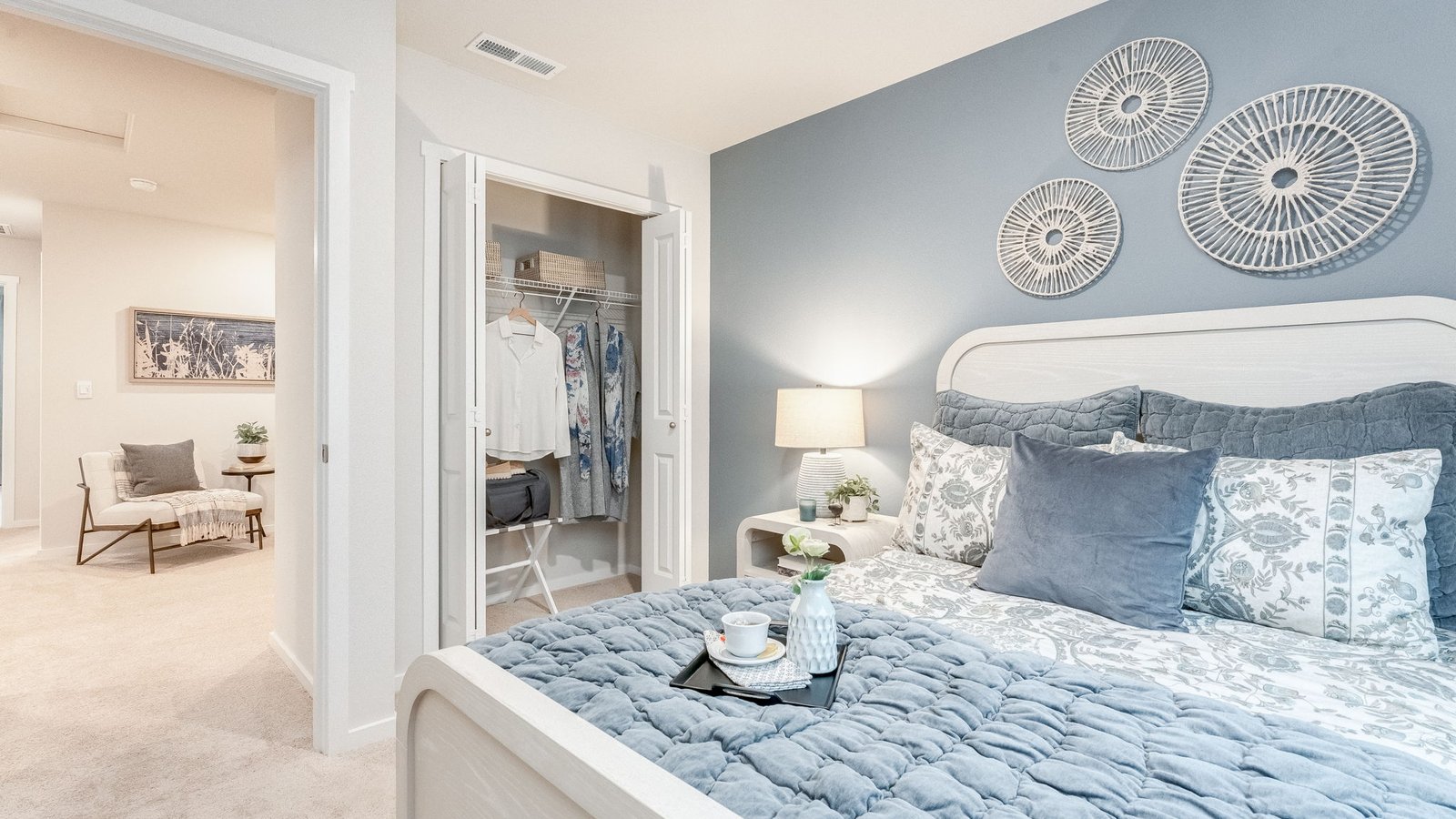 Bedroom with wall-to-wall carpet and a closet