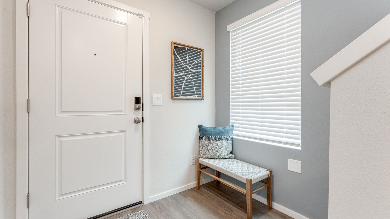 Entryway with a coat closet and laminate flooring