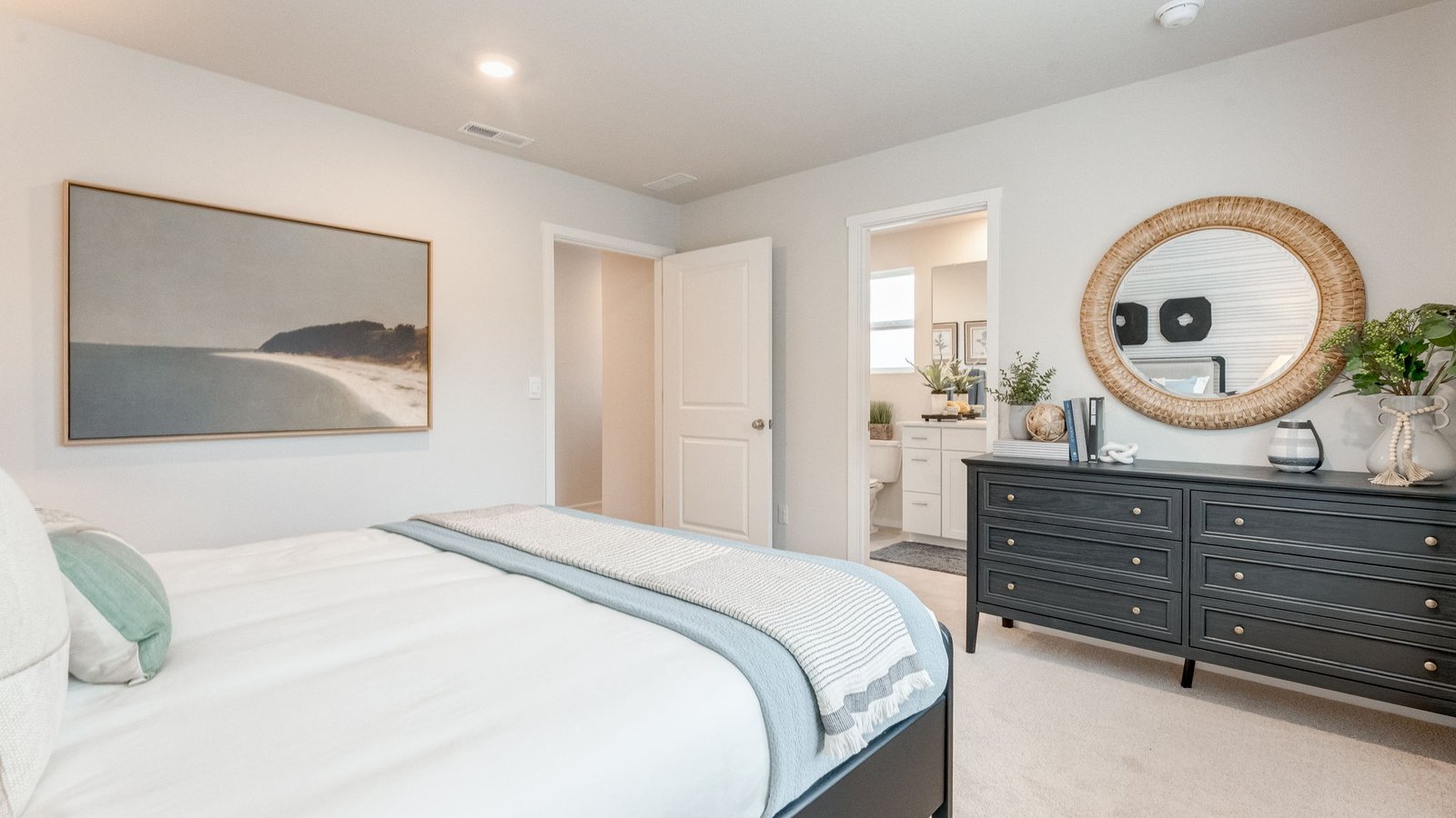 Primary bedroom with wall-to-wall carpet, a walk-in closet and an attached bathroom