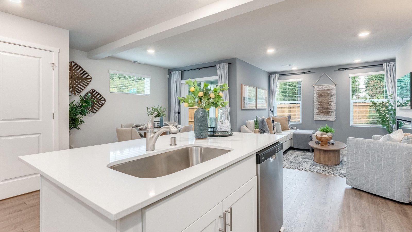 Kitchen with shaker cabinets, quartz counters, stainless steel appliances, pantry, and an island with a breakfast bar