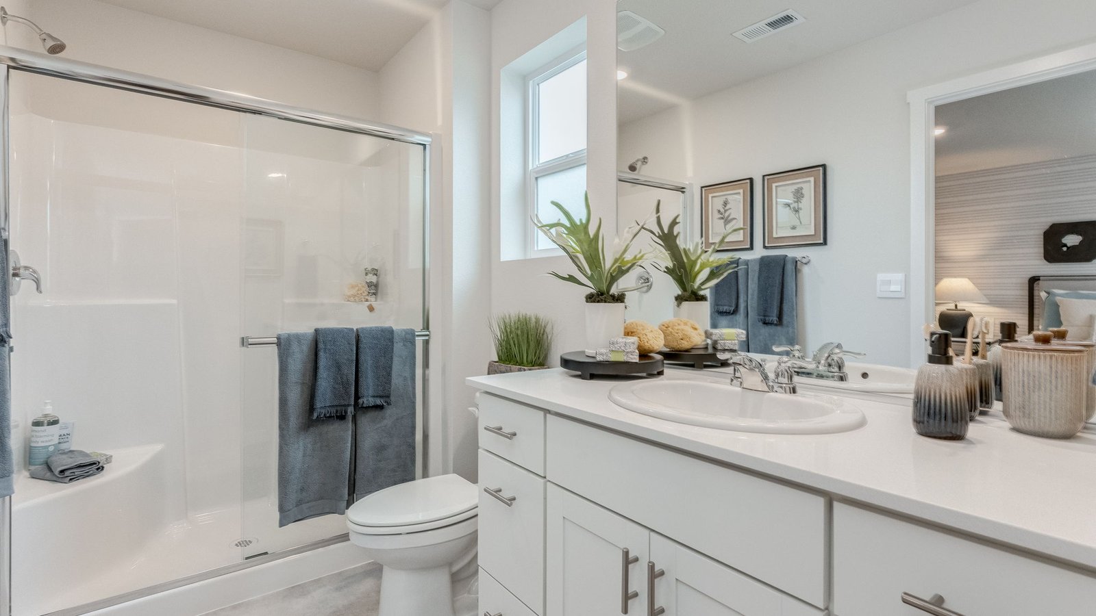 Primary bathroom with quartz counters and a walk-in shower