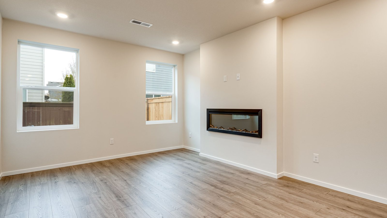 Great room with laminate flooring and an electric fireplace