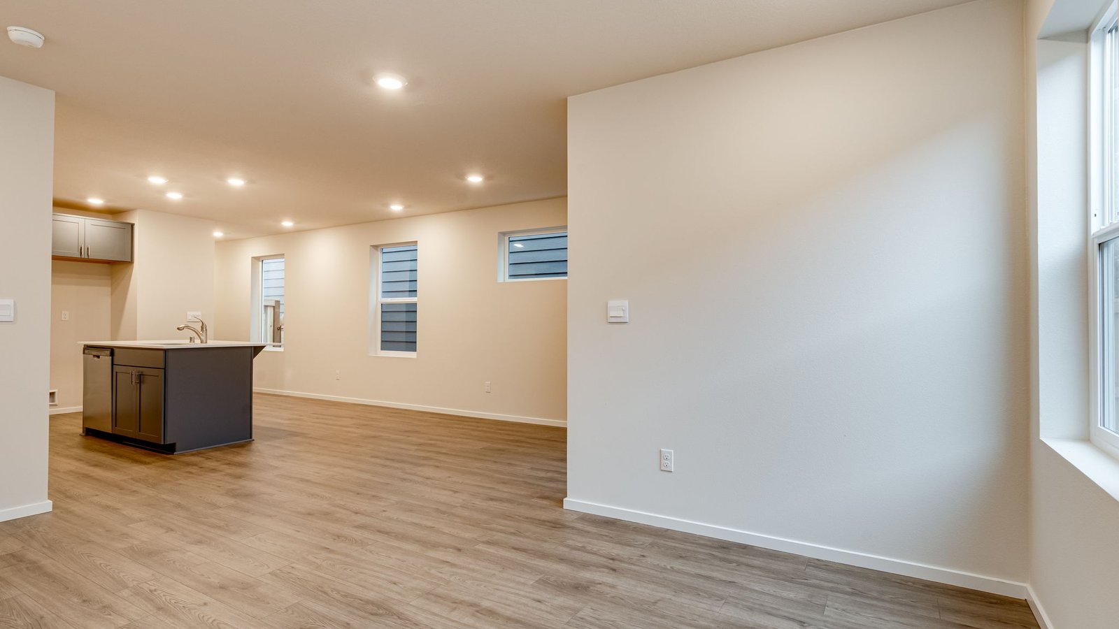 Great room with laminate flooring and an electric fireplace