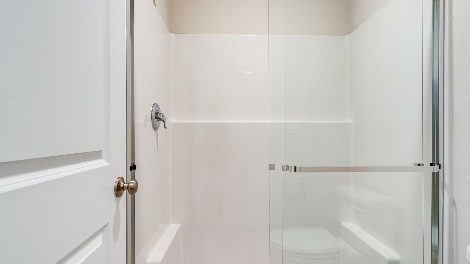 Primary bathroom with quartz counters and a walk-in shower