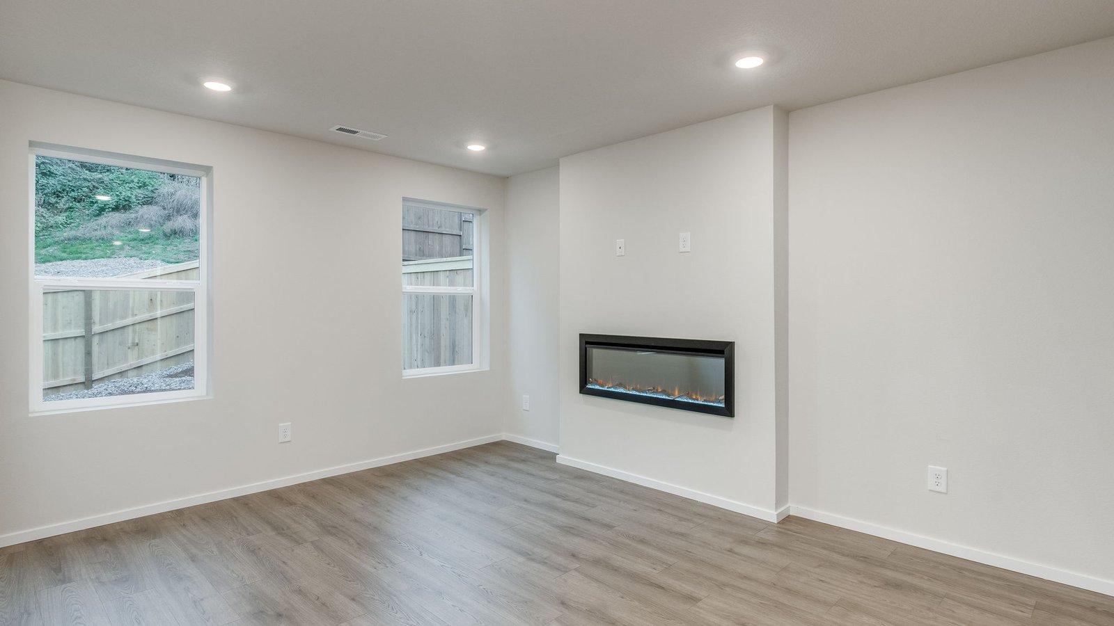 Great room with laminate flooring and an electric fireplace