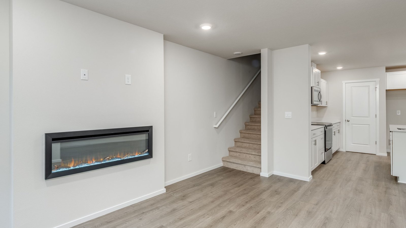 Great room with laminate flooring and an electric fireplace