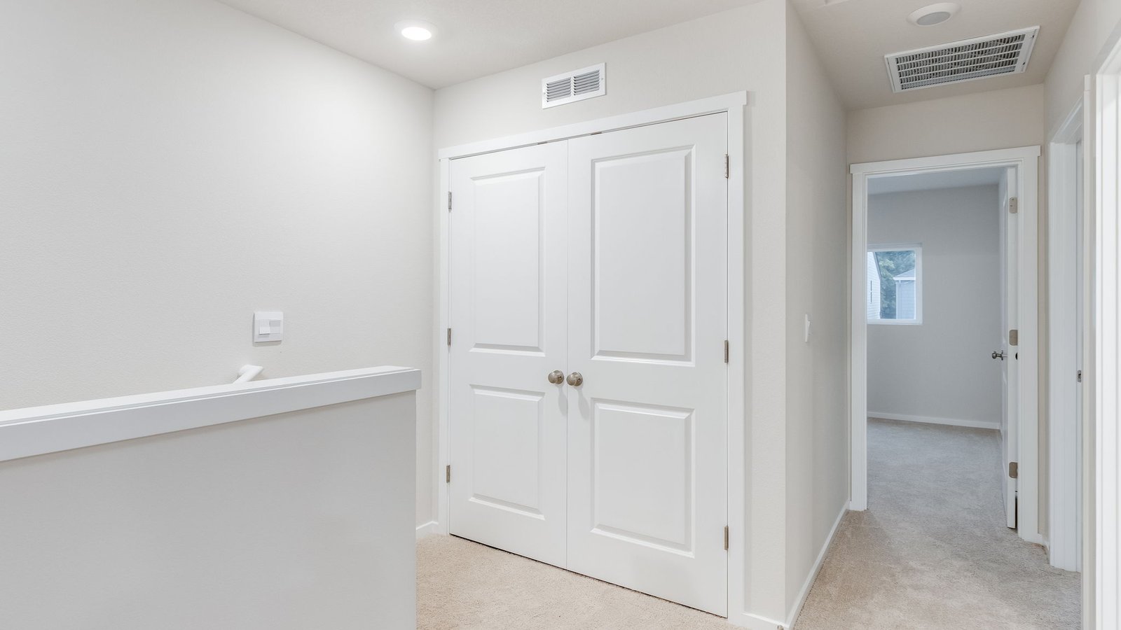Hallway with wall-to-wall carpet