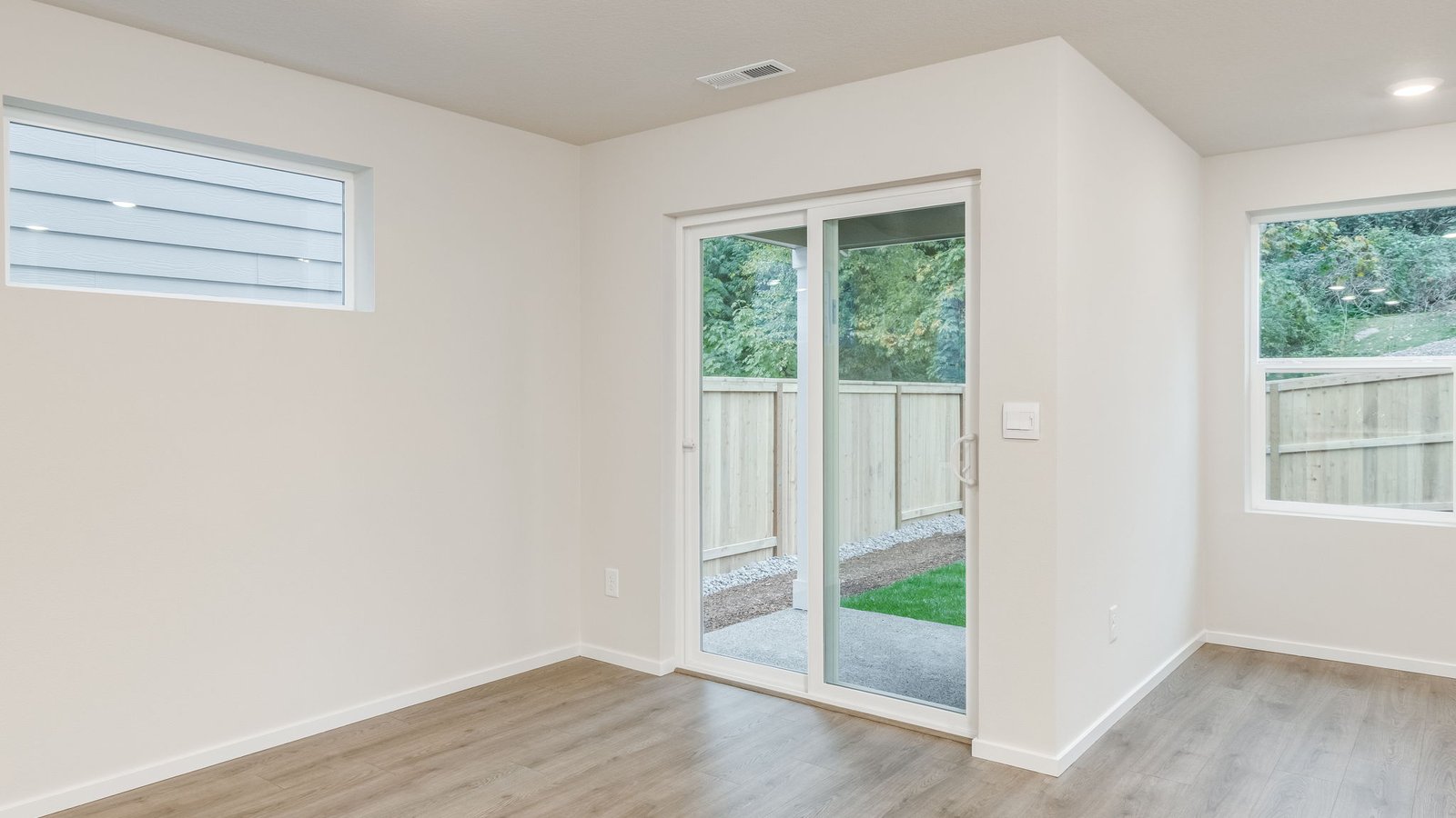 Dining area with a sliding glass door to a fenced backyard