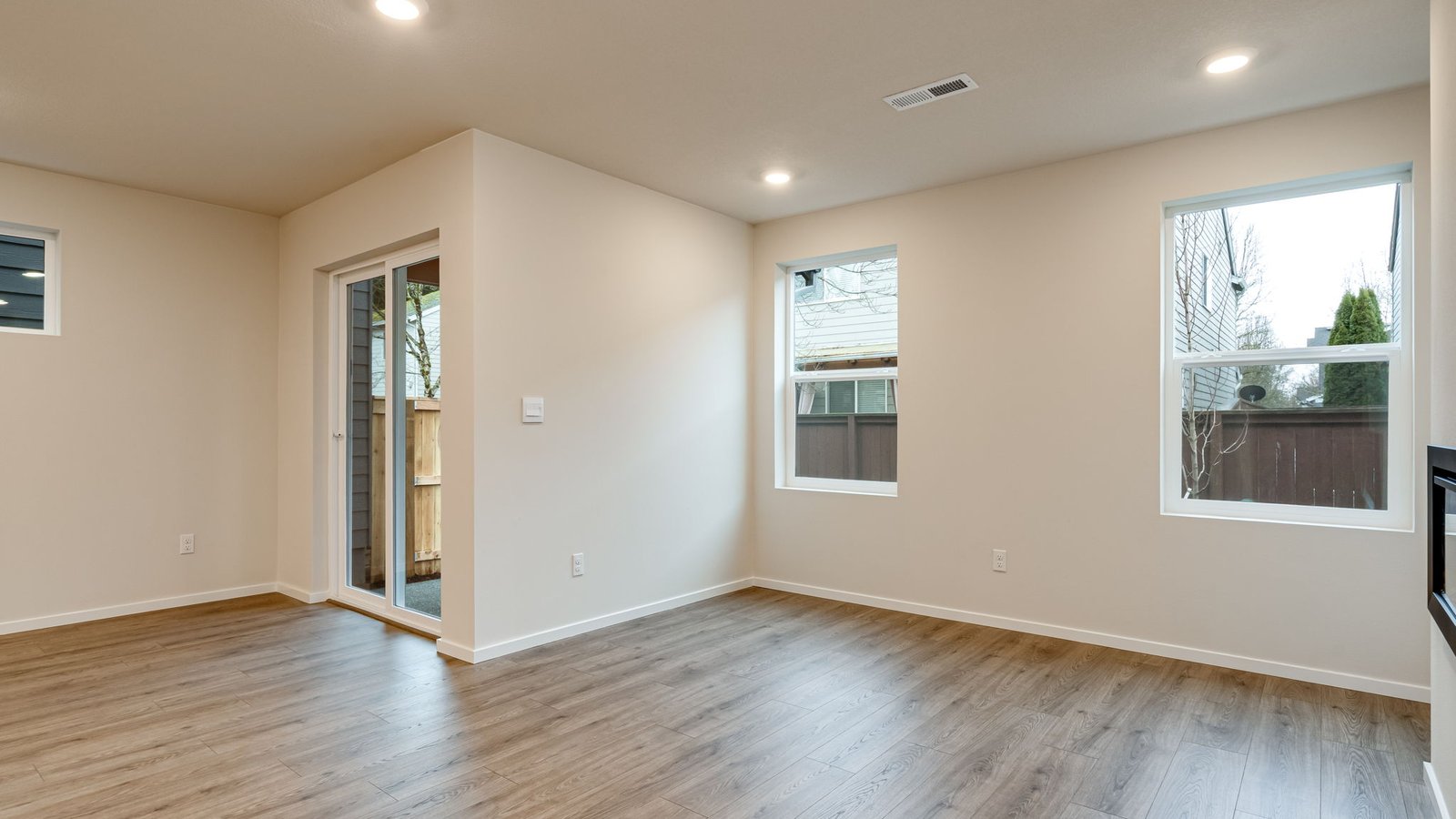 Great room with laminate flooring and an electric fireplace