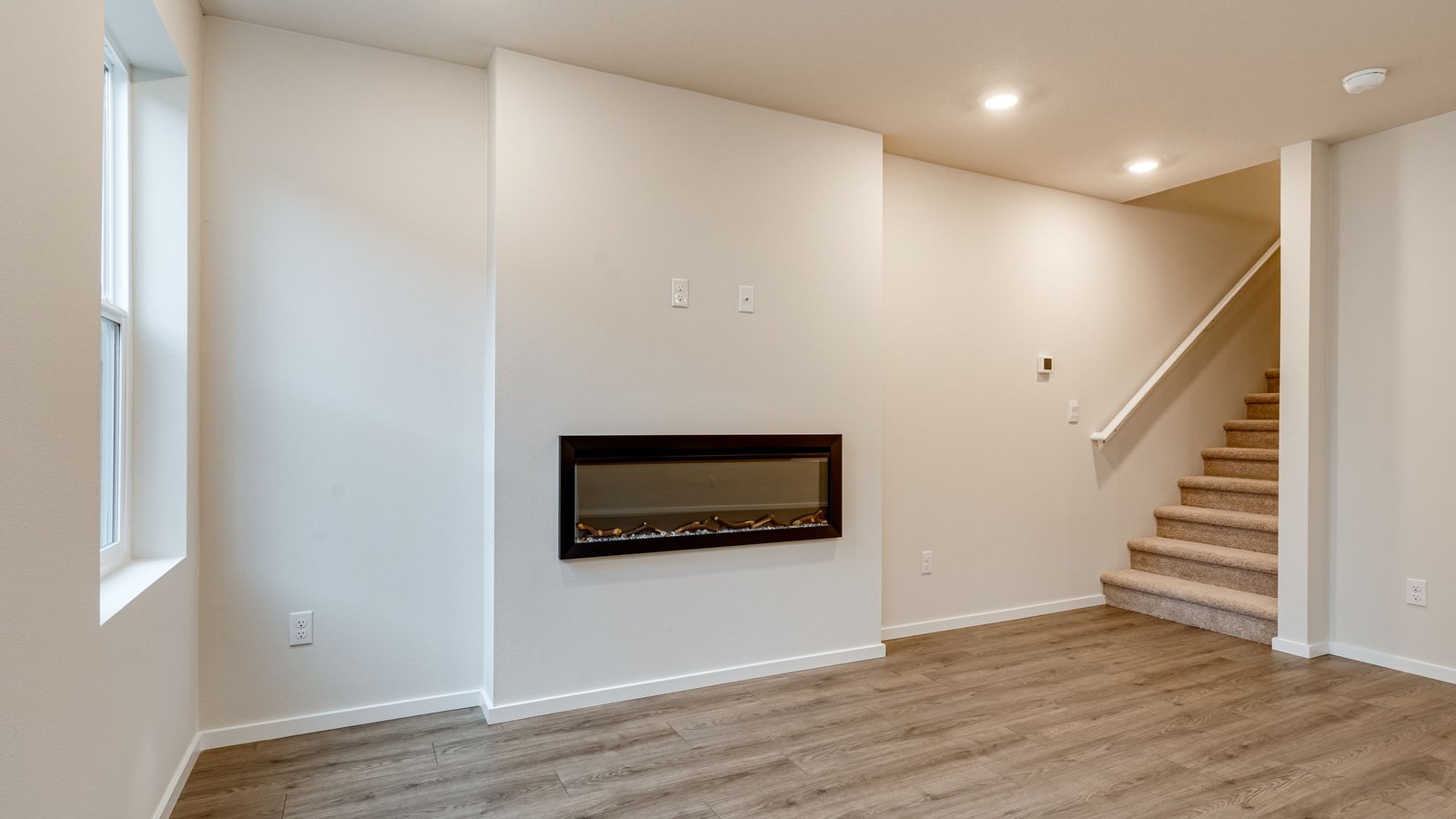 Great room with laminate flooring and an electric fireplace