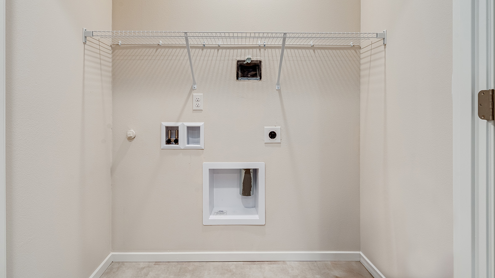 Laundry closet with wire shelves and washer and dryer hookups
