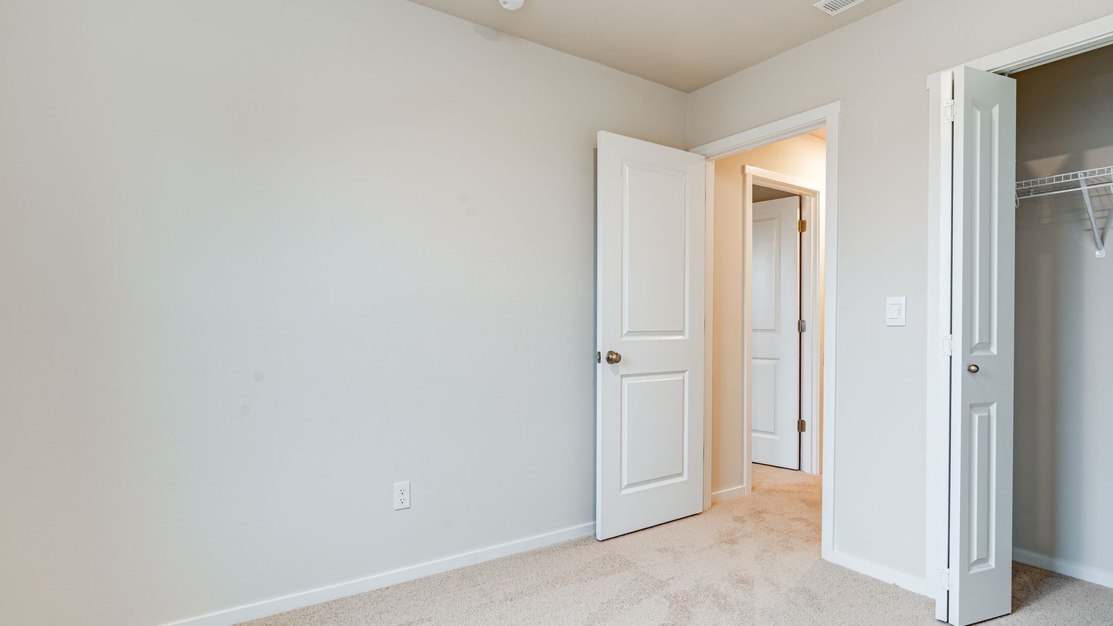 Bedroom with wall-to-wall carpet and a closet
