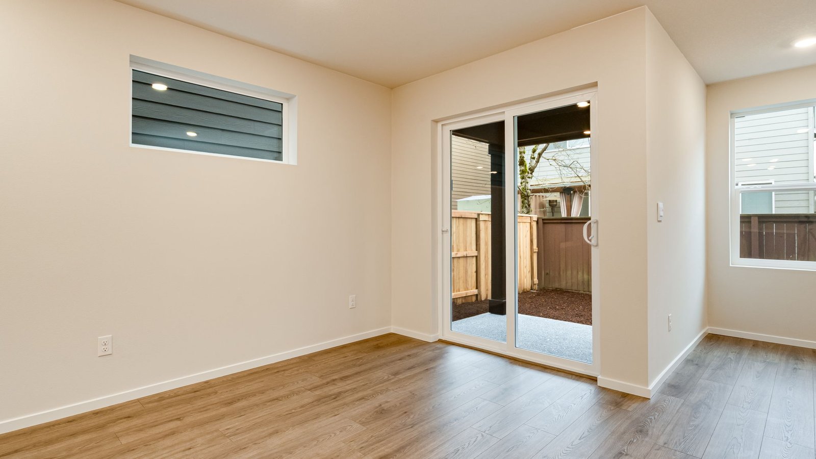 Dining area with a sliding glass door to a fenced backyard