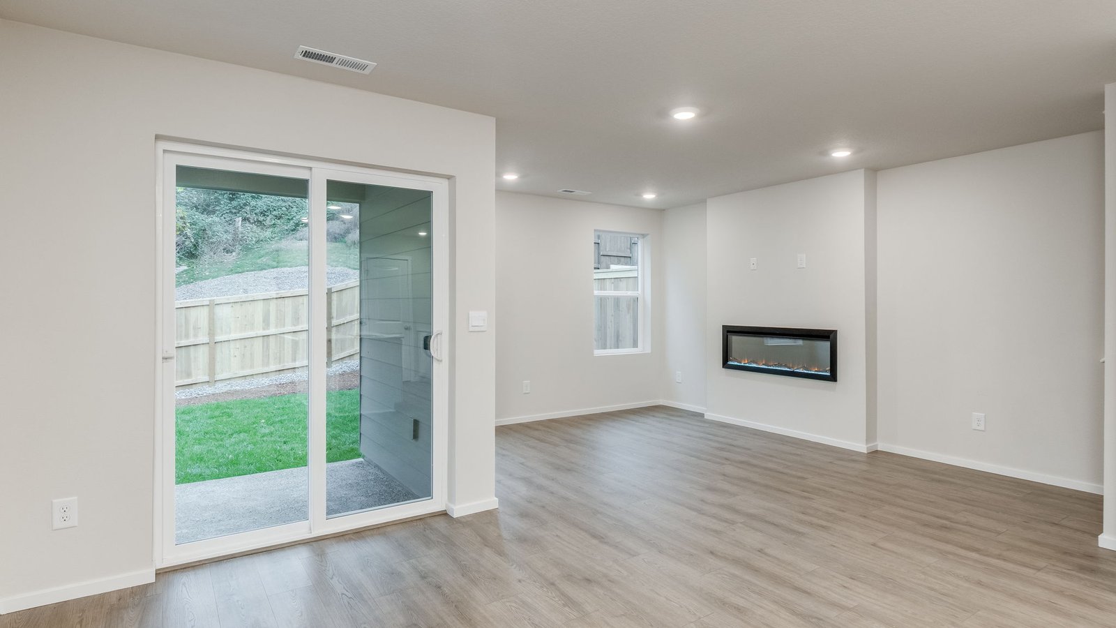 Great room with laminate flooring and an electric fireplace
